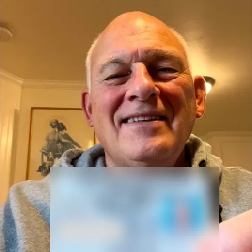 A Boston Firearms student holding up their new Massachusetts License to Carry, details blurred.